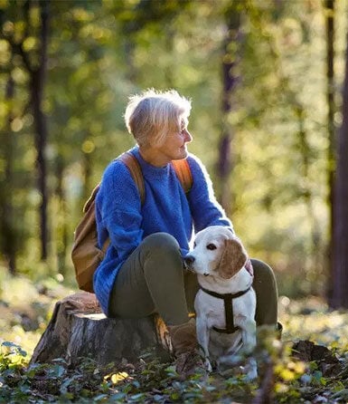 a-senior-woman-with-dog-on-a-walk-outdoors-in-forest a-senior-woman-with-dog-on-a-walk-outdoors-in-forest